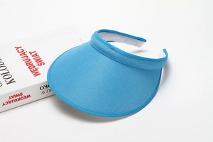 Detail view of blue mesh sun hat with adjustable hook and loop strap on a white surface