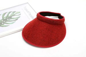 Detail of red knit sun visor hat with textured fabric and stylish open top design