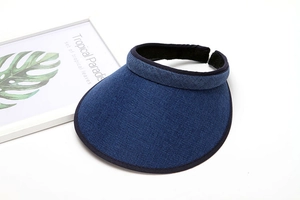 Detail of navy woven sun visor hat with adjustable back and tropical palm leaf decor