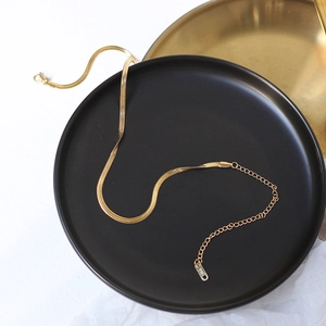 Elegant 18K gold plated snake chain choker with adjustable clasp on a black matte display