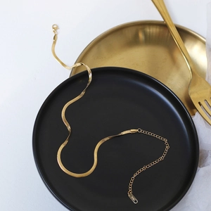 Detail of 14K gold plated flat snake chain choker with adjustable lobster clasp closure