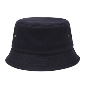 Detailed close-up of stitching on dark blue canvas bucket hat with metal eyelets