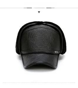 Close-up of black faux leather aviator cap with earflaps and soft fleece lining detail