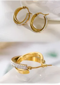 Macro detail of gold layered hoop earrings with one polished and one paved diamond ring