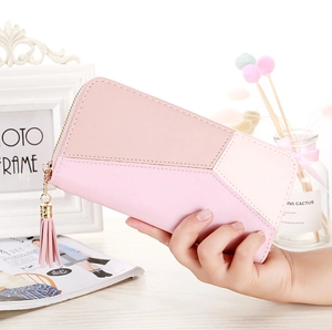 Detail of pink geometric patchwork long wallet with a matching tassel zipper charm