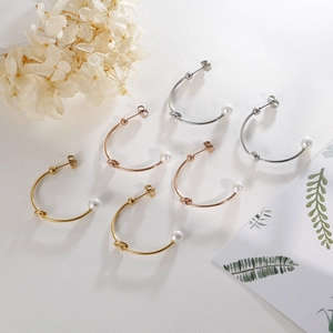 Three pairs of C-shaped knot stud earrings with pearls in gold, rose gold, and silver finish