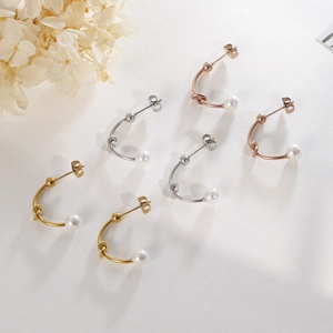 Three pairs of C-shaped metal pearl earrings in gold, silver, and rose gold finishes