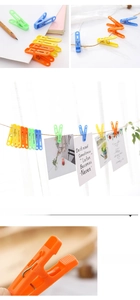 Detail showing the non-slip serrated grip and metal spring of these colorful plastic clothes pegs