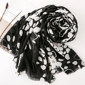 Floral print cotton linen shawl with white flower pattern and fringed edges on white background