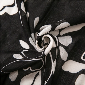 Macro shot of cotton linen scarf showing black and white leaf print and fabric texture