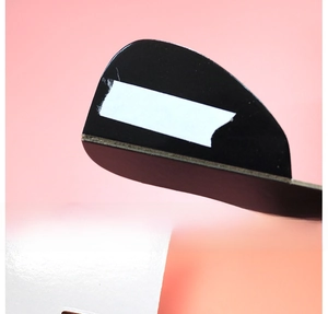 Detail of a one-tier paper cupcake stand showing the black arch support and white surface