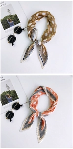 Flat lay of pleated silk scarves featuring brown polka dots and orange stripes patterns