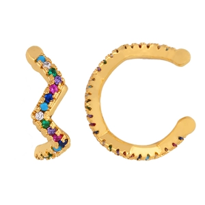 Close-up of gold ear cuff set featuring colorful pavé zircons in wave and C-ring shapes