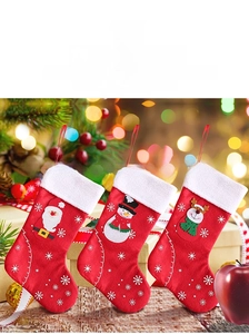 Close-up of three felt Christmas stockings featuring Santa, Snowman, and Reindeer motifs