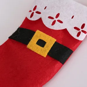 Close-up of thick red felt Christmas cutlery holder with black belt and buckle detail