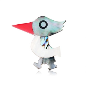 Close-up of bird brooch featuring colorful abalone shell inlay and red beak details