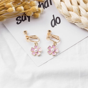 Pink floral enamel stud earrings with pearl centers and adjustable golden screw-on clips