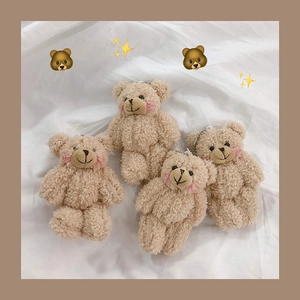 Set of four cute apricot plush bear keychains with metal bead chains on white fabric