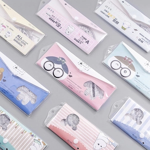 Macro view of assorted translucent frosted stationery pouches with secure snap buttons