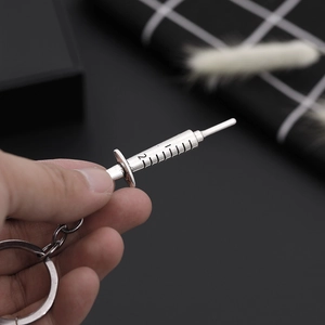 Silver syringe pendant keychain for medical gifts featuring realistic scale markings