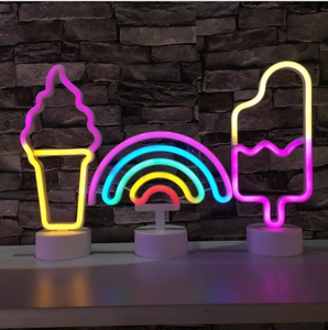 Close-up of LED neon lights showing ice cream, rainbow and popsicle shapes on bases