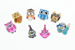 Set of eight colorful owl enamel pins featuring doctor and baby graduation themes