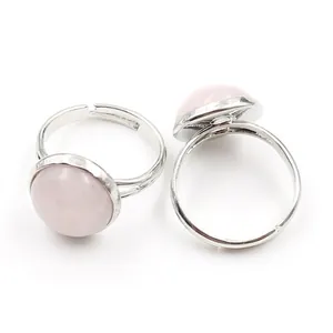 Adjustable silver ring set featuring polished round pink quartz crystal stones