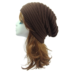 Detailed close-up of brown knit beanie showing coarse texture and vertical stripes on mannequin