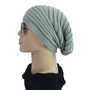 Detail of light grey ribbed knit beanie showing thick wool texture and slouchy fit