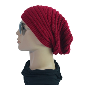 Detail of burgundy ribbed knit beanie showing thick wool texture and warm winter weave