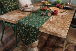 Detail of Christmas green table runner with golden snowflakes and festive patterns