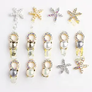 Detailed macro view of star-shaped alloy nail charms and pearl pendant DIY accessories