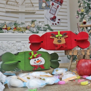 Foldable felt Christmas candy gift bags featuring reindeer and snowman designs in a cozy setting