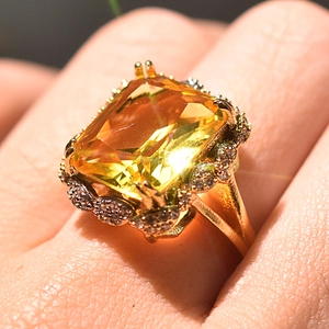 Close-up of champagne square diamond ring with gold finish and micro-inlaid zircon