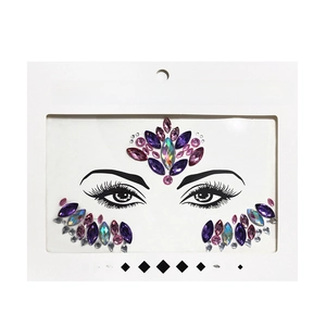 Detail view of purple and pink face crystal stickers in transparent window packaging