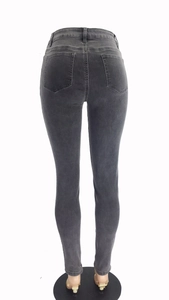 Detail view of high waist skinny grey denim jeans showing back pockets and stitching
