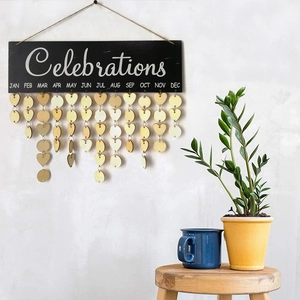 Detailed view of a wooden birthday calendar plaque with hanging heart and round discs