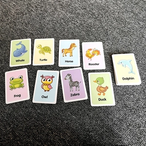 Close-up of educational flash cards featuring colorful cartoon animals and English names