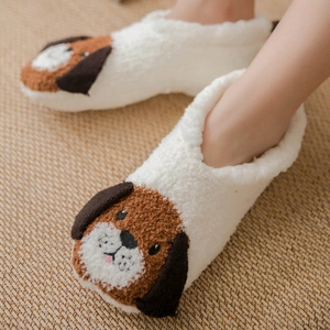 White coral fleece slipper socks with cute brown puppy design on warm woven carpet