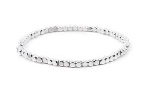 Detailed view of silver elastic beaded bracelet with square metallic facets on white backdrop