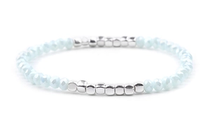 Detail of light blue faceted beads and silver square metal beads on elastic bracelet