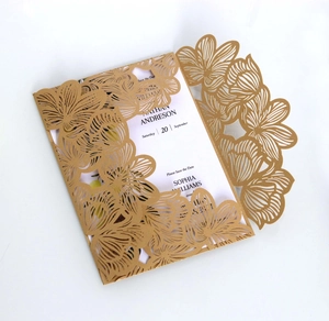 Detail of laser-cut gold floral invitation with white card and Save the Date text