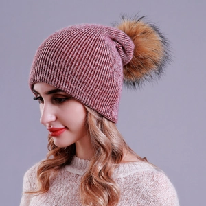Detailed knit texture and fluffy faux fur pompom on this winter knit beanie for women