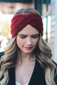 Detail of dark red chunky knit headband with a stylish crossover twist design