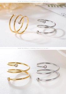 Macro detail of multi-layer spiral rings in gold and silver with sparkling rhinestones