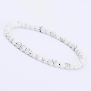 Detailed macro view of 4mm white turquoise stone beads with marble texture for a bracelet