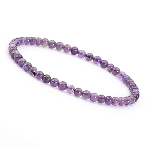Macro detail of 4mm natural amethyst beads on a minimalist purple gemstone bracelet