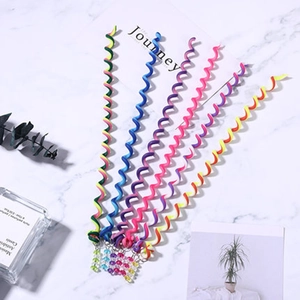 Colorful spiral hair braiding tools for girls with decorative beads on marble surface