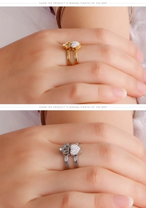 Detail view of gold and silver crown heart rings with sparkling zircon inlay on fingers