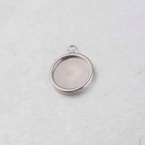 Macro detail of round silver stainless steel pendant tray for DIY jewelry setting